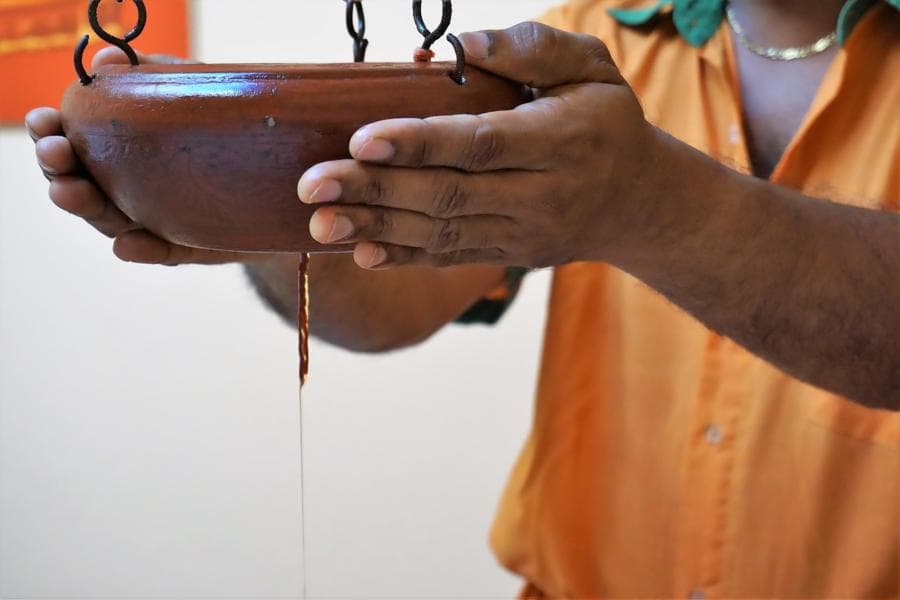 Ayurvedic forehead oil pouring